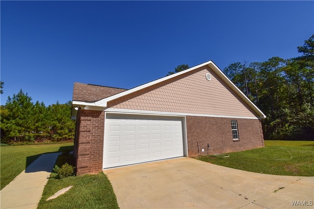 view of side of property with a garage and a lawn