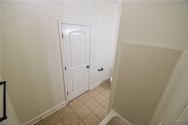 hall featuring light tile patterned floors