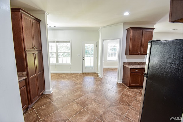 kitchen featuring black fridge and crown molding