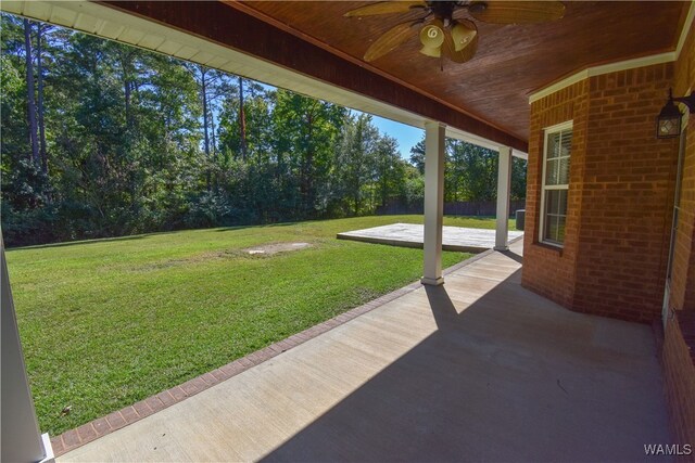 view of yard with ceiling fan and a patio