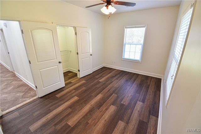 unfurnished bedroom with dark hardwood / wood-style floors and ceiling fan