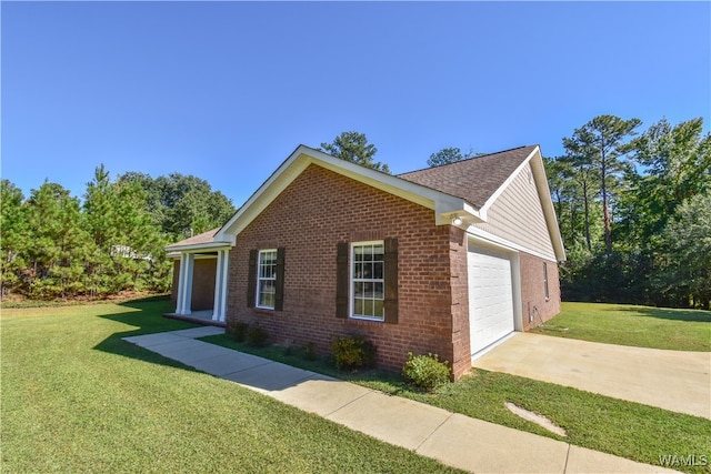 view of side of property featuring a yard and a garage