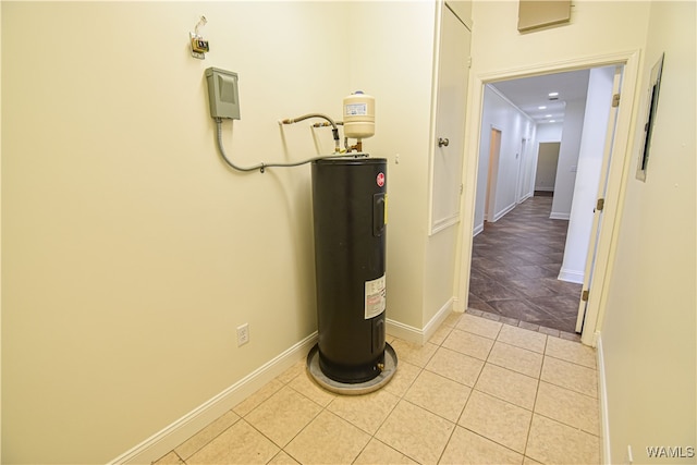 hallway featuring light tile patterned floors and water heater