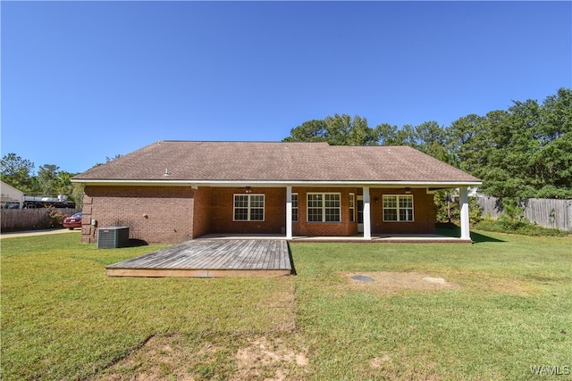 back of property featuring a lawn, central AC, and a deck