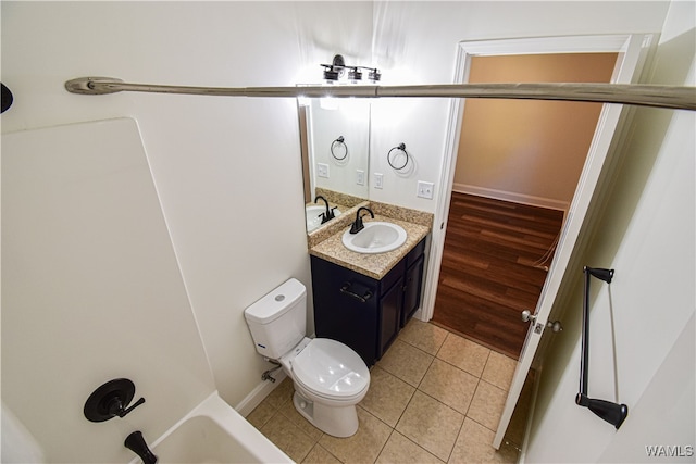 bathroom featuring tile patterned flooring, vanity, and toilet