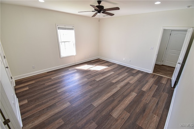 unfurnished room with ceiling fan and dark wood-type flooring