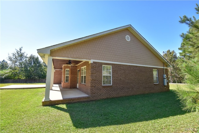 back of house featuring a yard, ceiling fan, and a patio area