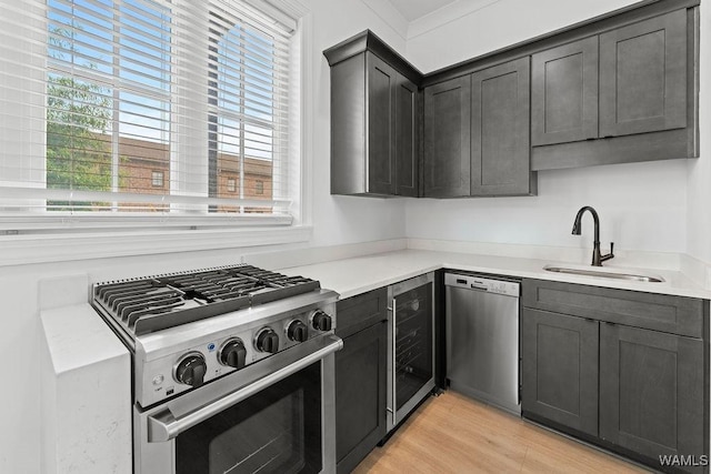 800 Red Drew Ave, Tuscaloosa, AL 35401 - kitchen featuring appliances with stainless steel finishes, light countertops, beverage cooler, and light wood-style flooring