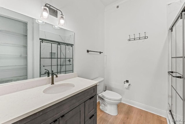800 Red Drew Ave, Tuscaloosa, AL 35401 - bathroom featuring a shower stall, vanity, wood finished floors, and a walk in closet