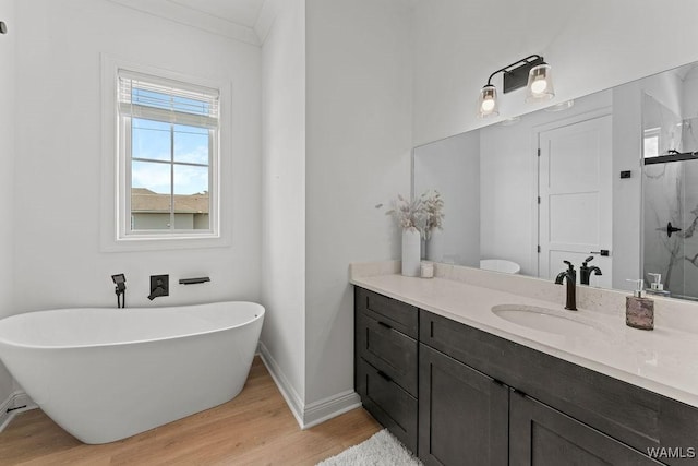800 Red Drew Ave, Tuscaloosa, AL 35401 - full bath with vanity, a freestanding tub, wood finished floors, a marble finish shower, and crown molding