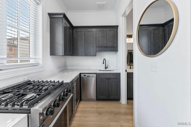 800 Red Drew Ave, Tuscaloosa, AL 35401 - kitchen featuring stainless steel appliances, light countertops, light wood-style floors, and ornamental molding