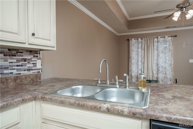 kitchen featuring tasteful backsplash, dishwasher, sink, white cabinets, and crown molding