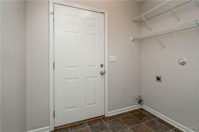 clothes washing area featuring dark tile patterned flooring and electric dryer hookup