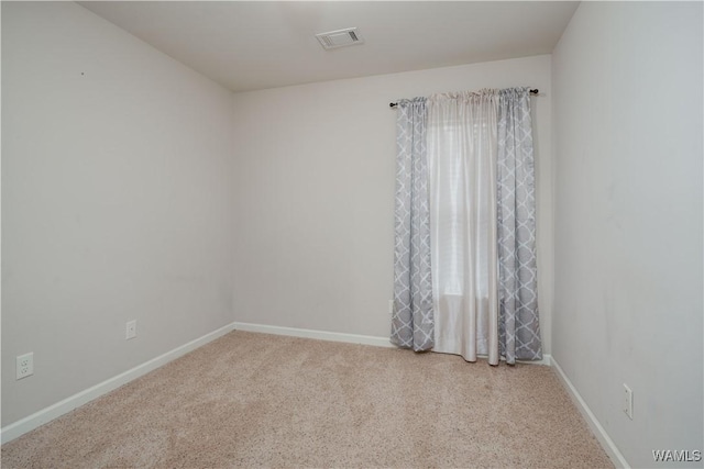 spare room with light colored carpet