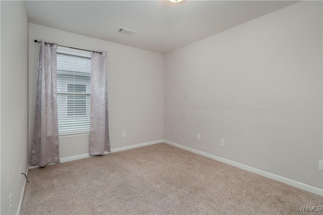 unfurnished room featuring light colored carpet