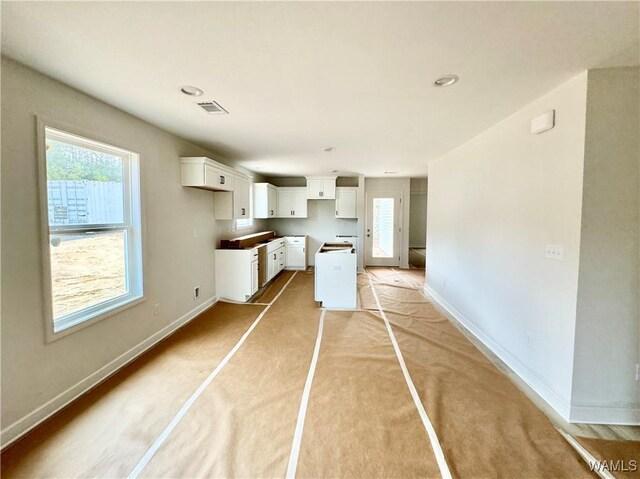 unfurnished living room featuring ceiling fan and dark hardwood / wood-style flooring