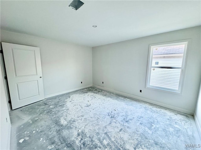 unfurnished room featuring baseboards