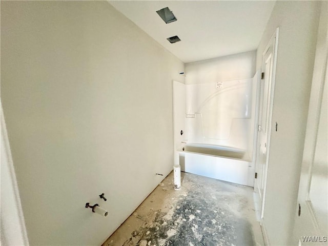 full bath with unfinished concrete flooring and  shower combination