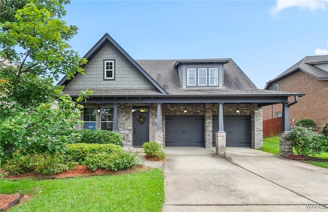 9437 Crete Cir, Tuscaloosa, AL 35406 - craftsman-style home featuring driveway, brick siding, a front lawn, and roof with shingles