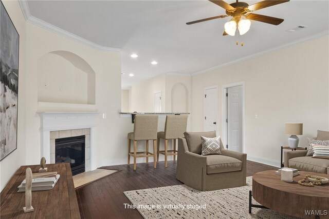 9437 Crete Cir, Tuscaloosa, AL 35406 - living room with crown molding, recessed lighting, hardwood / wood-style floors, ceiling fan, and a tile fireplace