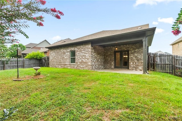 9437 Crete Cir, Tuscaloosa, AL 35406 - back of house featuring brick siding, a fenced backyard, a patio, and french doors