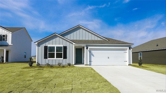 view of front of home featuring roof with shingles, concrete driveway, an attached garage, board and batten siding, and a front yard