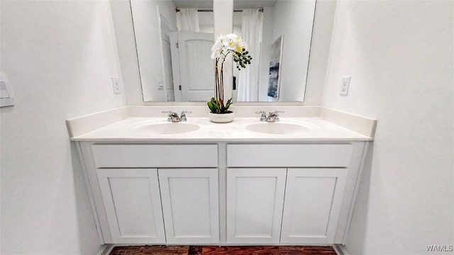 full bath with double vanity and a sink