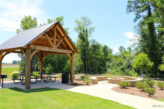 surrounding community with a gazebo, a fire pit, a patio area, and a lawn