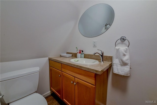 bathroom featuring vanity and toilet