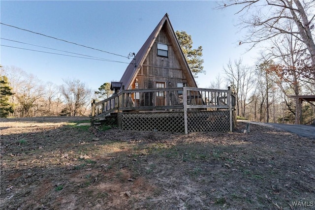 back of house with a wooden deck