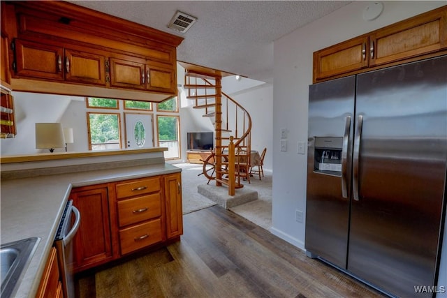 kitchen featuring sink, dark wood-type flooring, stainless steel appliances, and a textured ceiling