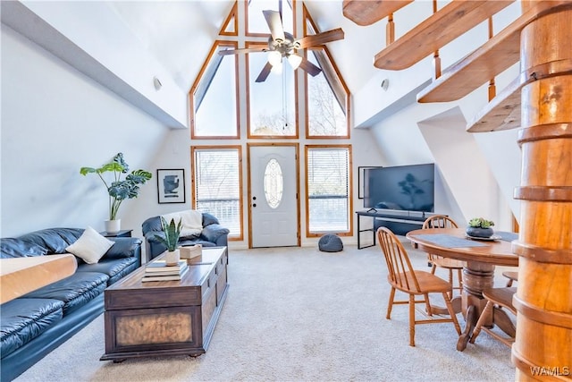 living room featuring light colored carpet, high vaulted ceiling, and ceiling fan