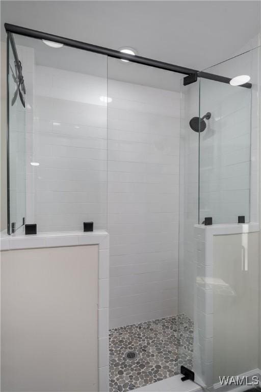 bathroom with a shower with door