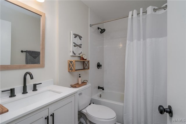 full bathroom featuring vanity, shower / bath combination with curtain, and toilet