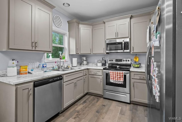 19026 Eastern Valley Rd, West Blocton, AL 35184 - kitchen with appliances with stainless steel finishes, a sink, ornamental molding, wood finished floors, and gray cabinets