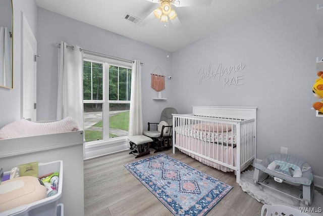 19026 Eastern Valley Rd, West Blocton, AL 35184 - bedroom featuring a nursery area, wood finished floors, and a ceiling fan