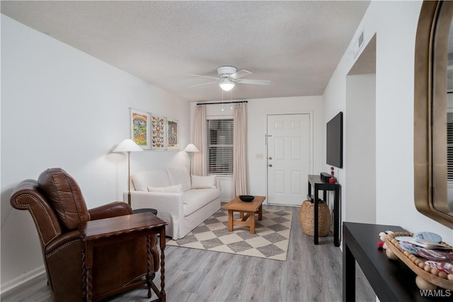 1009 12th St Unit 19, Tuscaloosa, AL 35401 - living area with ceiling fan, light wood-style floors, and a textured ceiling