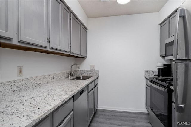 1009 12th St Unit 19, Tuscaloosa, AL 35401 - kitchen with appliances with stainless steel finishes, gray cabinetry, and wood finished floors