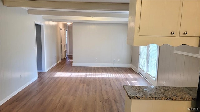 interior space with beamed ceiling and light hardwood / wood-style floors