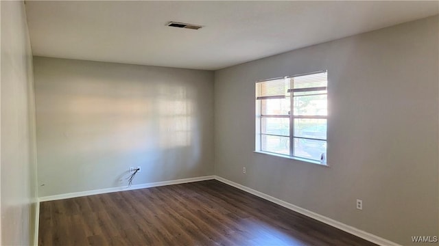 unfurnished room with dark hardwood / wood-style floors