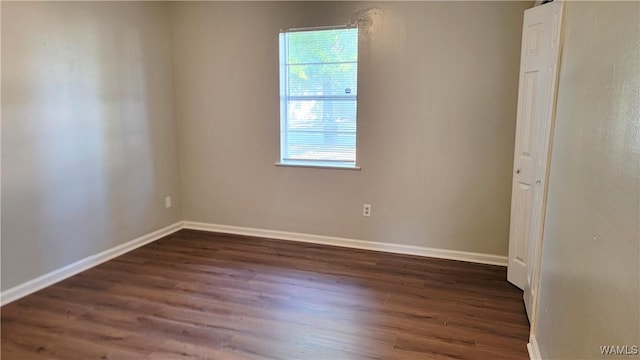 unfurnished room featuring dark hardwood / wood-style floors