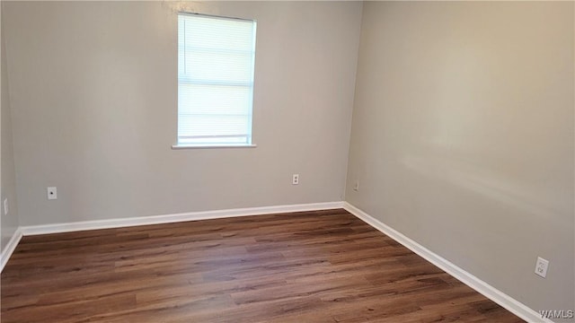 unfurnished room featuring dark hardwood / wood-style floors