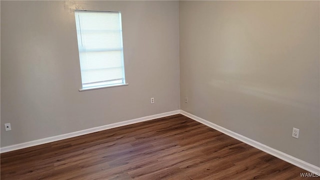 empty room featuring dark hardwood / wood-style flooring