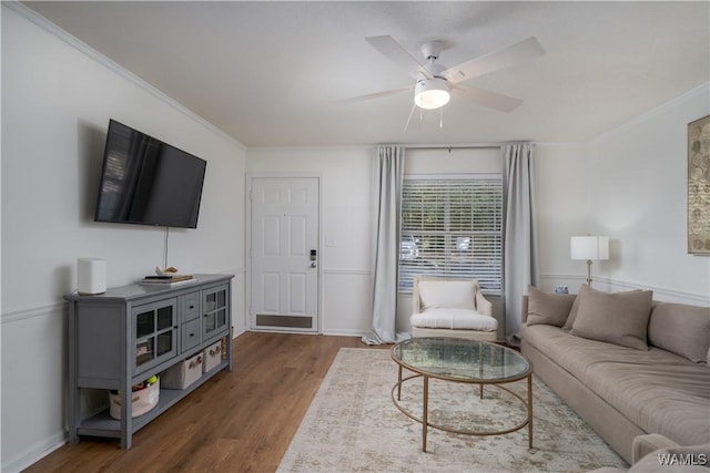 living room with ceiling fan, dark wood-type flooring, and crown molding