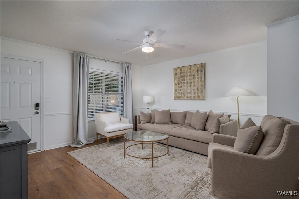 living room with ceiling fan, wood-type flooring, and crown molding