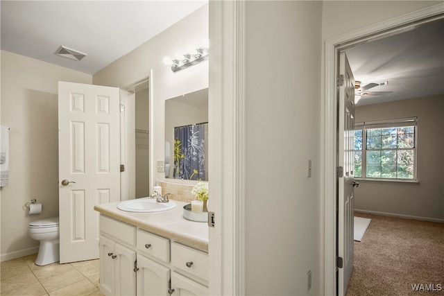 bathroom featuring tile patterned floors, ceiling fan, vanity, and toilet