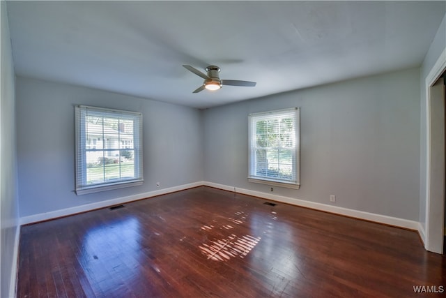 unfurnished room featuring dark hardwood / wood-style floors and ceiling fan