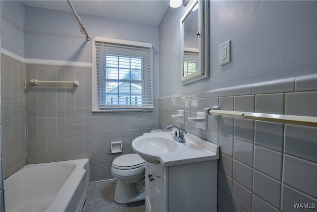 full bathroom with tile patterned floors, vanity, toilet, and tile walls