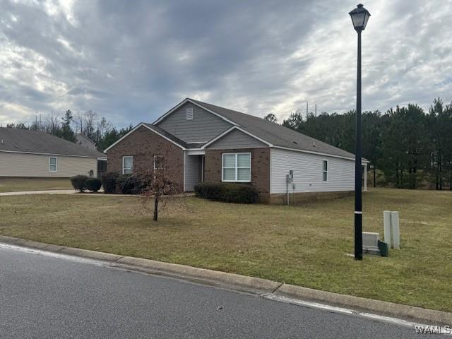 view of front of house with brick siding and a front yard