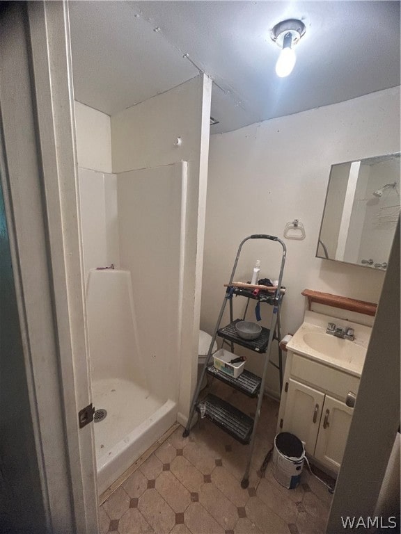 bathroom featuring a shower and vanity